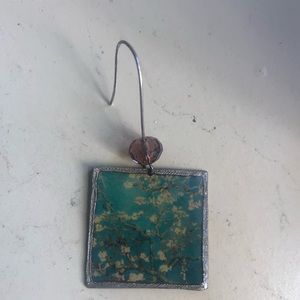 Three different single earrings.